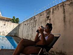 Mature mom in the buff takes a backyard shower observed by a curious neighbor